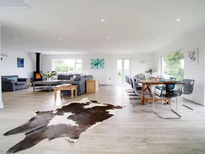 a living room with a cow rug on the floor at Port View House in Bodmin