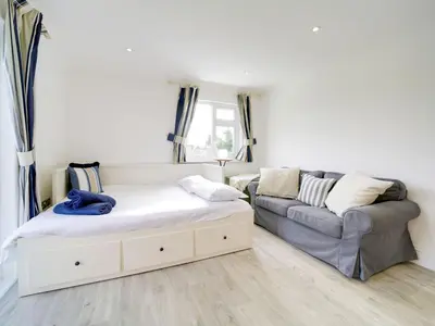 a living room with two beds and a couch at Port View House in Bodmin