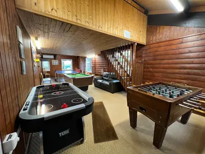 a living room with a ping pong table and a ping pong table at Malt-Barn Conversion, with access to Pool & Hot Tub-at Fox Valley Cottages in Lansallos