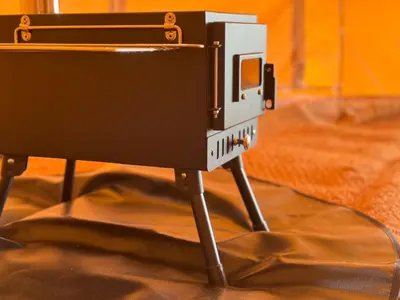 a camera on a tripod on a table at Furnished Bell Tent 4 in St Austell