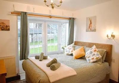 a bedroom with a bed with towels on it at Seaview Stable Barn in Penryn