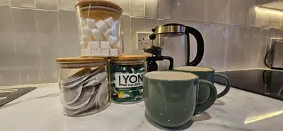 a counter with two coffee cups and a blender at Shorebreak Apartment 1 in Newquay