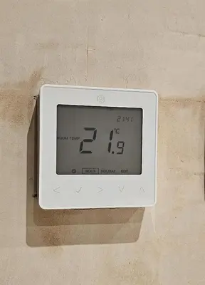 a digital clock on the side of a wall at Shorebreak Apartment 1 in Newquay