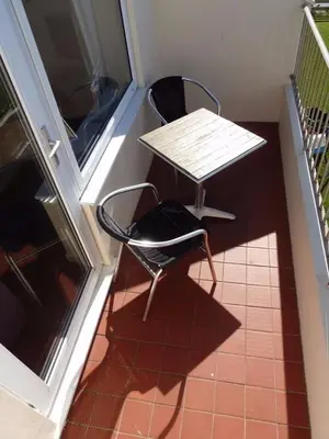 a small table and a chair in a room at Seaview Apartment in Phillack