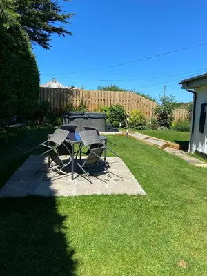 a table and two chairs sitting on a lawn at Little Dusty - Between St Agnes & Perranporth in St. Agnes
