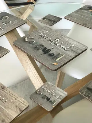 a group of wooden signs on a table at Little Dusty - Between St Agnes & Perranporth in St. Agnes