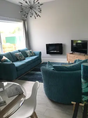 a living room with two couches and a tv at Little Dusty - Between St Agnes & Perranporth in St. Agnes