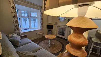 a living room with a couch and a table at Potted Shrimp in Saint Mawes