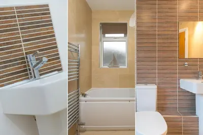 a bathroom with a tub and a toilet and a sink at Cockleshells in St Ives