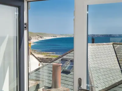 a view of the beach from a house door at The Loft in Porthleven