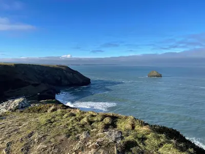 a view of the ocean with a rock in the water at Little Ruffo in Tintagel