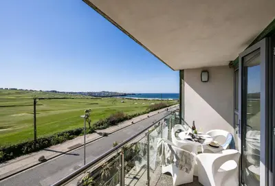 a balcony with a view of the ocean at Surfside 34 Zinc in Newquay in Newquay