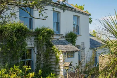 an old white house with ivy at Lamledra Farm House Apartment in Gorran Haven