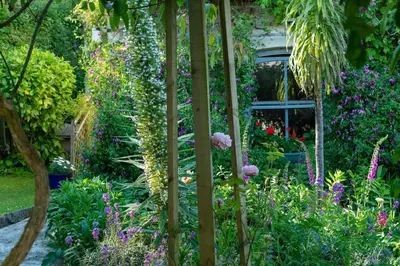 a garden with many different flowers and plants at Lamledra Farm House Apartment in Gorran Haven