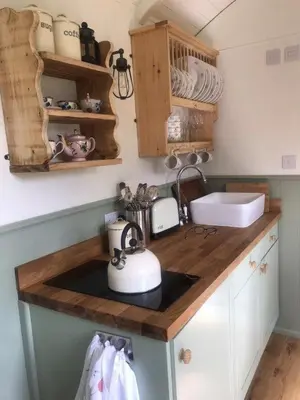 a kitchen counter with a sink and a tea kettle at Lovely Shepherds hut near St Ives Cornwall in Gwinear Road Station