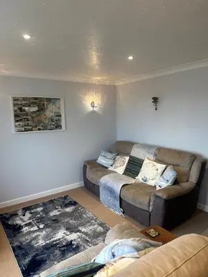a living room with a couch and a sectional at Penolva Beach Side Apartment in Perranporth