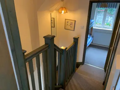 a hallway with a stairway leading to a room at Maypole Cottages -5 Mill Road in Padstow