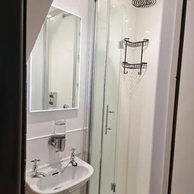 a bathroom with a sink and a shower at Maypole Cottages -5 Mill Road in Padstow