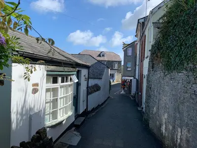 a small alley with white buildings and a street at - Maypole Cottages - No 2 Mill Road in Padstow