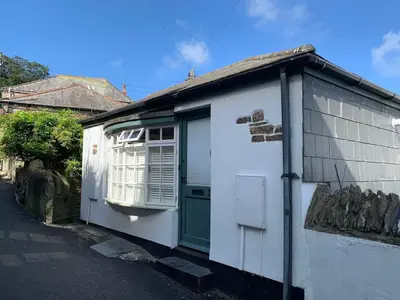a small house with a green door and a window at - Maypole Cottages - No 2 Mill Road in Padstow