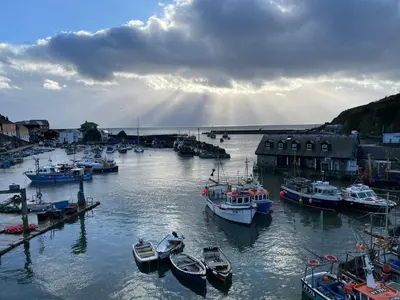 a group of boats are docked in a harbor at Cosy Cottage, Mevagissey in Mevagissey