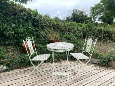 two chairs and a table and a table and chairs at Trelean Lodge in Leedstown