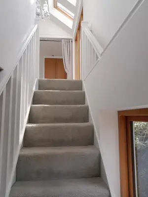 a staircase in a house with a skylight at Trelean Lodge in Leedstown