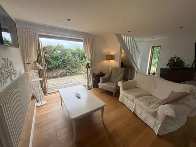 a living room with a couch and a table at Trelean Lodge in Leedstown