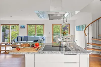 a kitchen with a counter top with vegetables on a cutting board at House 17 in Looe