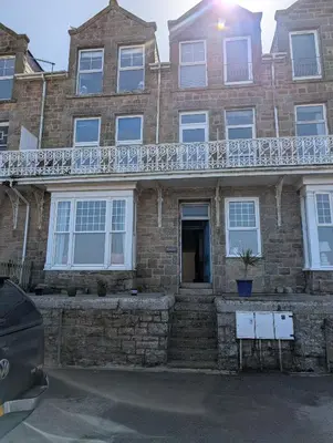 a brick house with a balcony on top of it at Bijou in St Ives