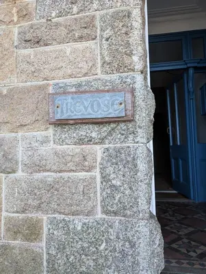 a sign on the side of a stone wall at Bijou in St Ives