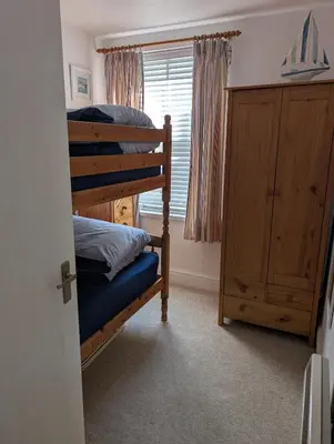 a bedroom with a bunk bed and a window at Bijou in St Ives