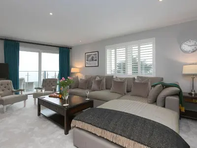 a living room with a bed and a couch at Wingspan in St Ives
