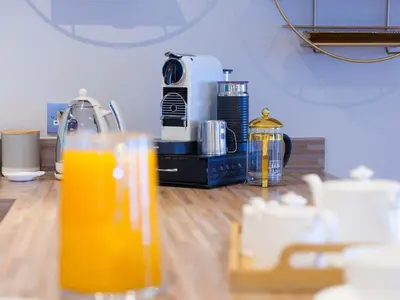 a glass of orange juice sitting on a table at Wingspan in St Ives