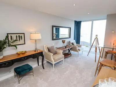 a living room with a table and chairs and a desk at Wingspan in St Ives
