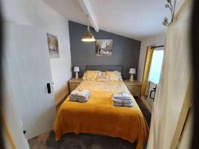 a bedroom with a bed with two towels on it at SeaView-PetsOK-Patio-1BR in Mevagissey