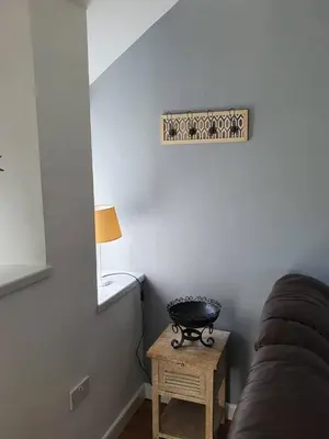 a room with a bed and a table with a lamp at SeaView-PetsOK-Patio-1BR in Mevagissey