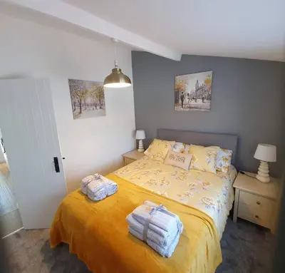 a bedroom with a bed with two towels on it at SeaView-PetsOK-Patio-1BR in Mevagissey