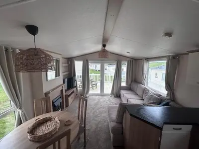 a living room with a couch and a table at 151 Newquay Bay Resort in Porth
