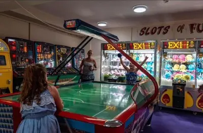 a young girl playing a game in a pinball at 151 Newquay Bay Resort in Porth