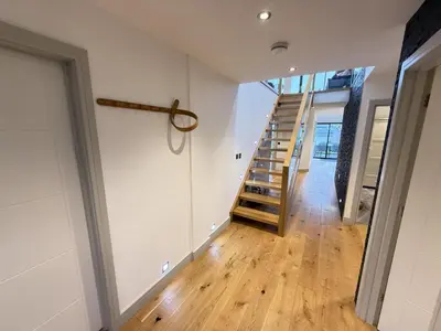 an empty hallway with a staircase in a house at Fishers View, Castle Approach, Tregenna Castle in St Ives