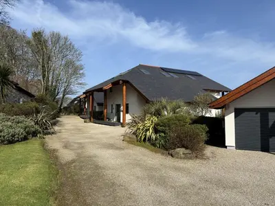a house with a driveway leading to a garage at Fishers View, Castle Approach, Tregenna Castle in St Ives