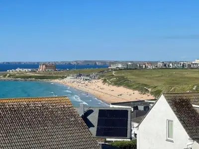 a view of a beach with some buildings and the ocean at Penthouse Sea View Newquay Fistral Beach 3 Min Walk in Crantock