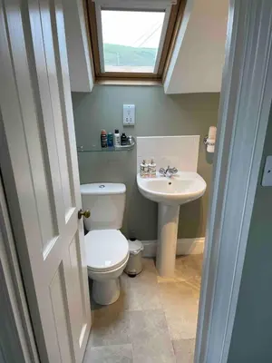 a small bathroom with a toilet and a sink at Sea Glimpses Studio Port Isaac in Port Isaac
