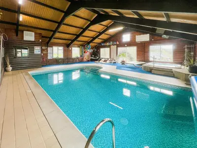 a large swimming pool in a large room with at Culver Cottage - Uk48987 in Looe