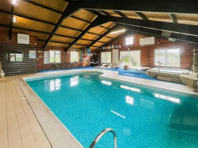 a large swimming pool in a building at Linney Cottage - Uk48986 in Looe
