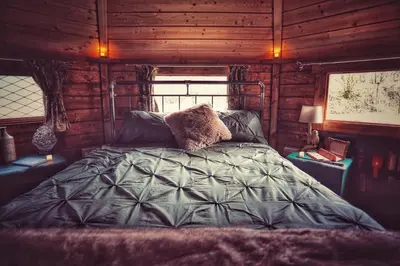 a bedroom with a bed in a log cabin at The Wizards Cauldron -Harry Potter Themed in Lewannick