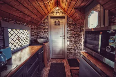 a kitchen with a door and a stone wall at The Wizards Cauldron -Harry Potter Themed in Lewannick