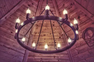a chandelier hanging from the ceiling of a wooden building at The Wizards Cauldron -Harry Potter Themed in Lewannick