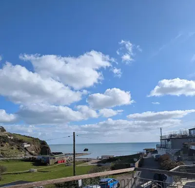a view of the ocean from a balcony at Luxury Sea View Chalet At Millendreath in Looe